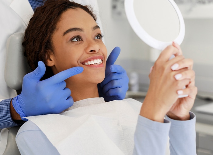 Dentist showing a patient her new smile