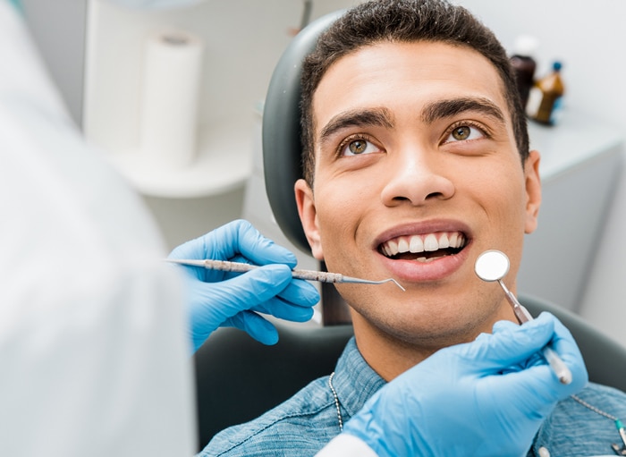 Dentist preparing to clean a patient's teeth